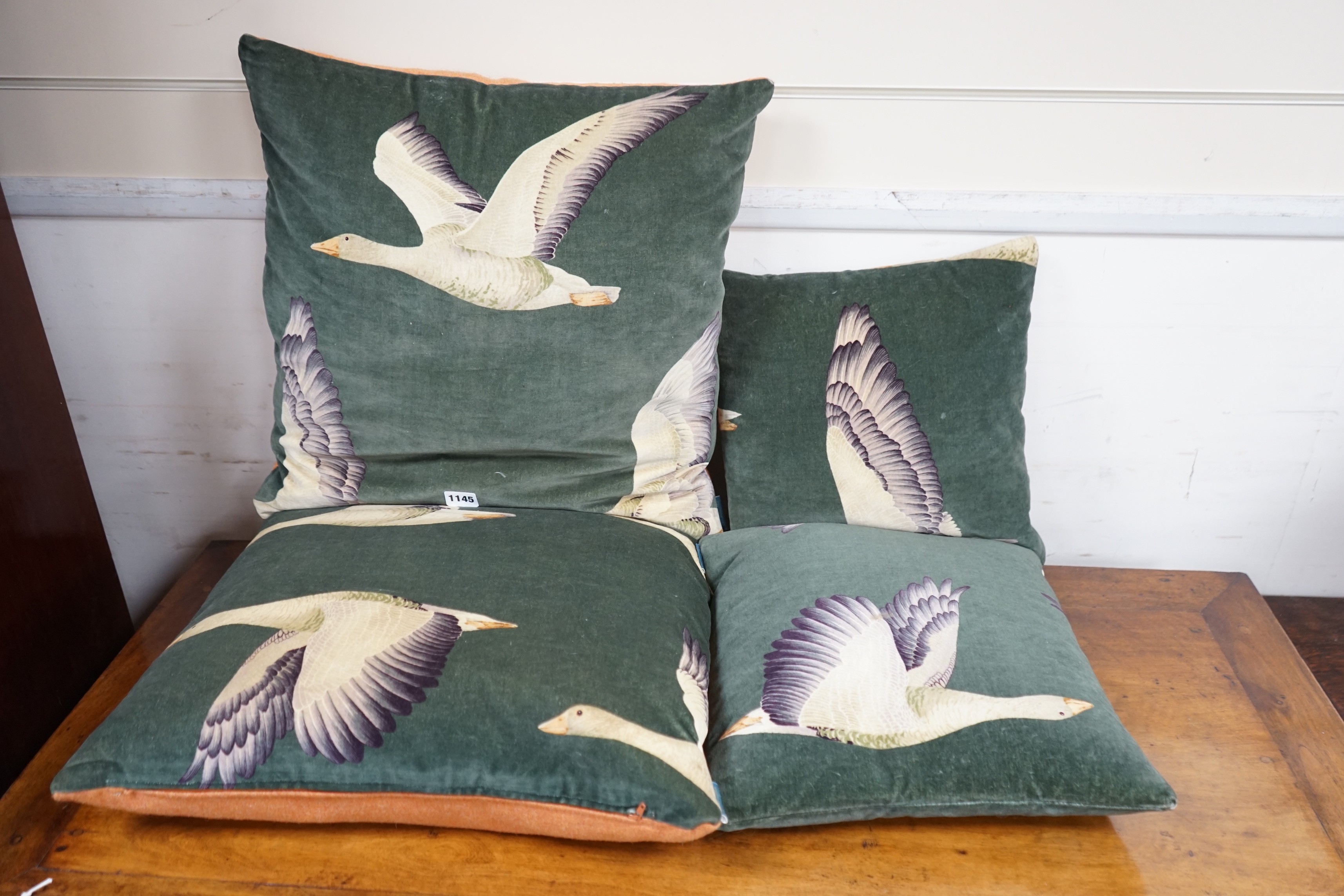 Two pairs of cushions decorated with geese